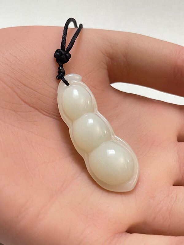 white jade carving of a three bean peapod pendant