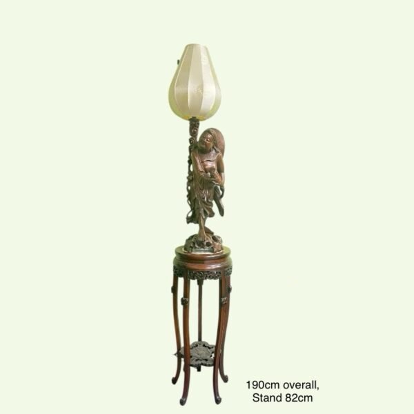 A Chinese carved hardwood lamp on stand
木雕刘海金蟾灯带座