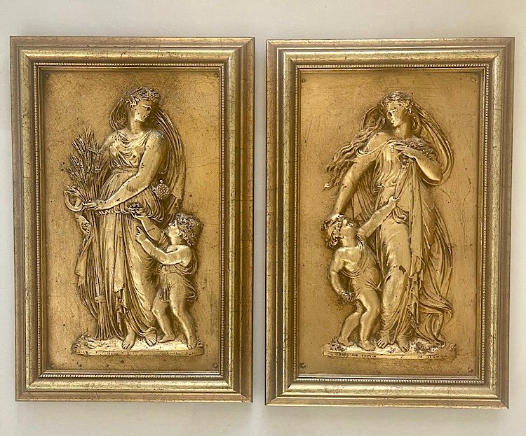 A pair of decorative high relief wall plaques.